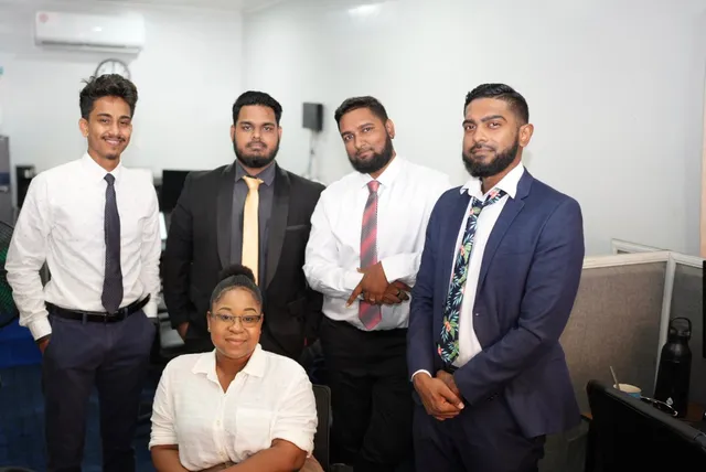 OSS staffing team of 13 employees outside their Georgetown, Guyana office